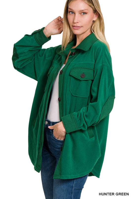 Woman wearing a green jacket with a white background