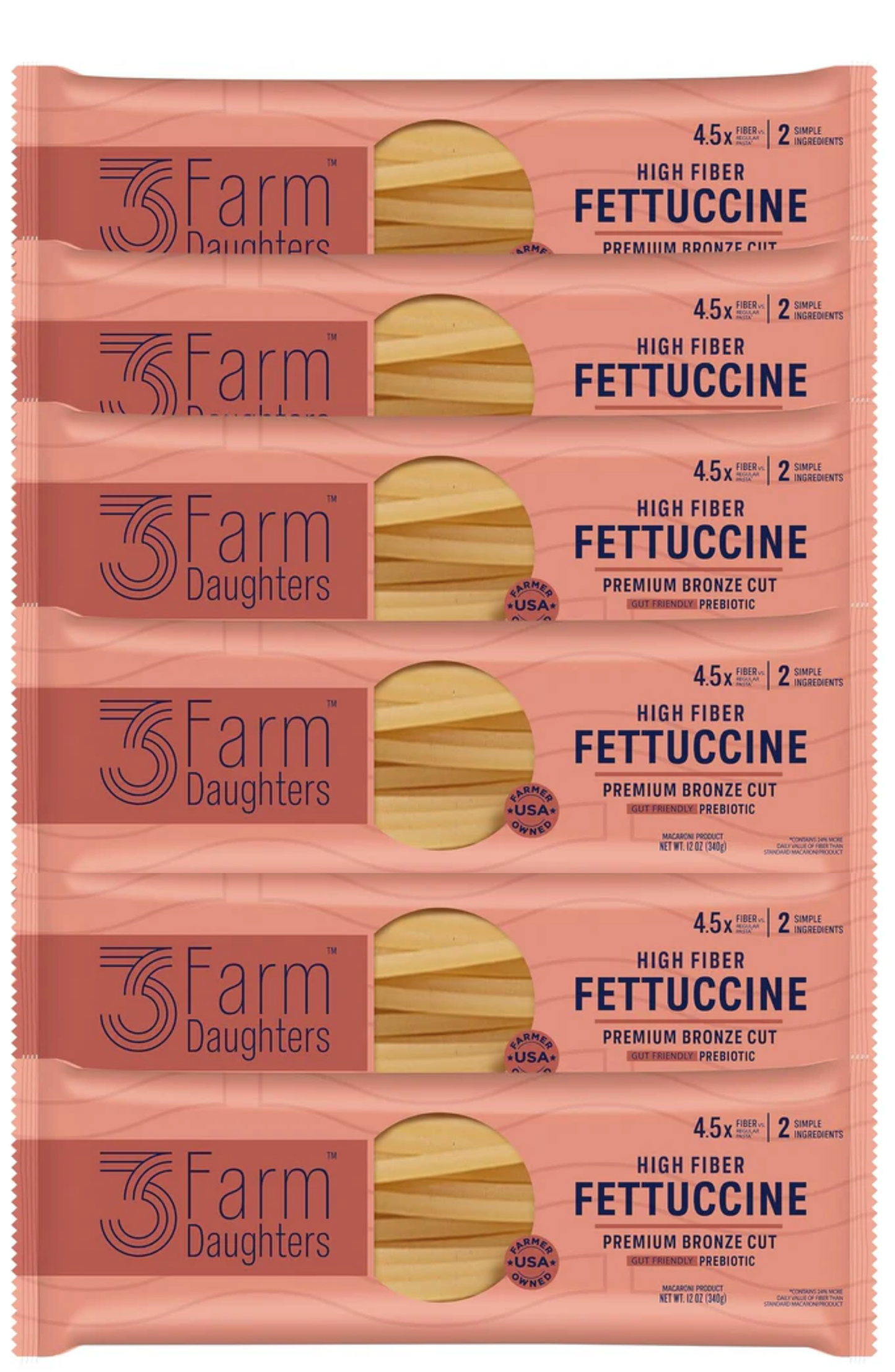 Multiple packages of 3 Farm Daughters Fettuccine pasta on a pink background